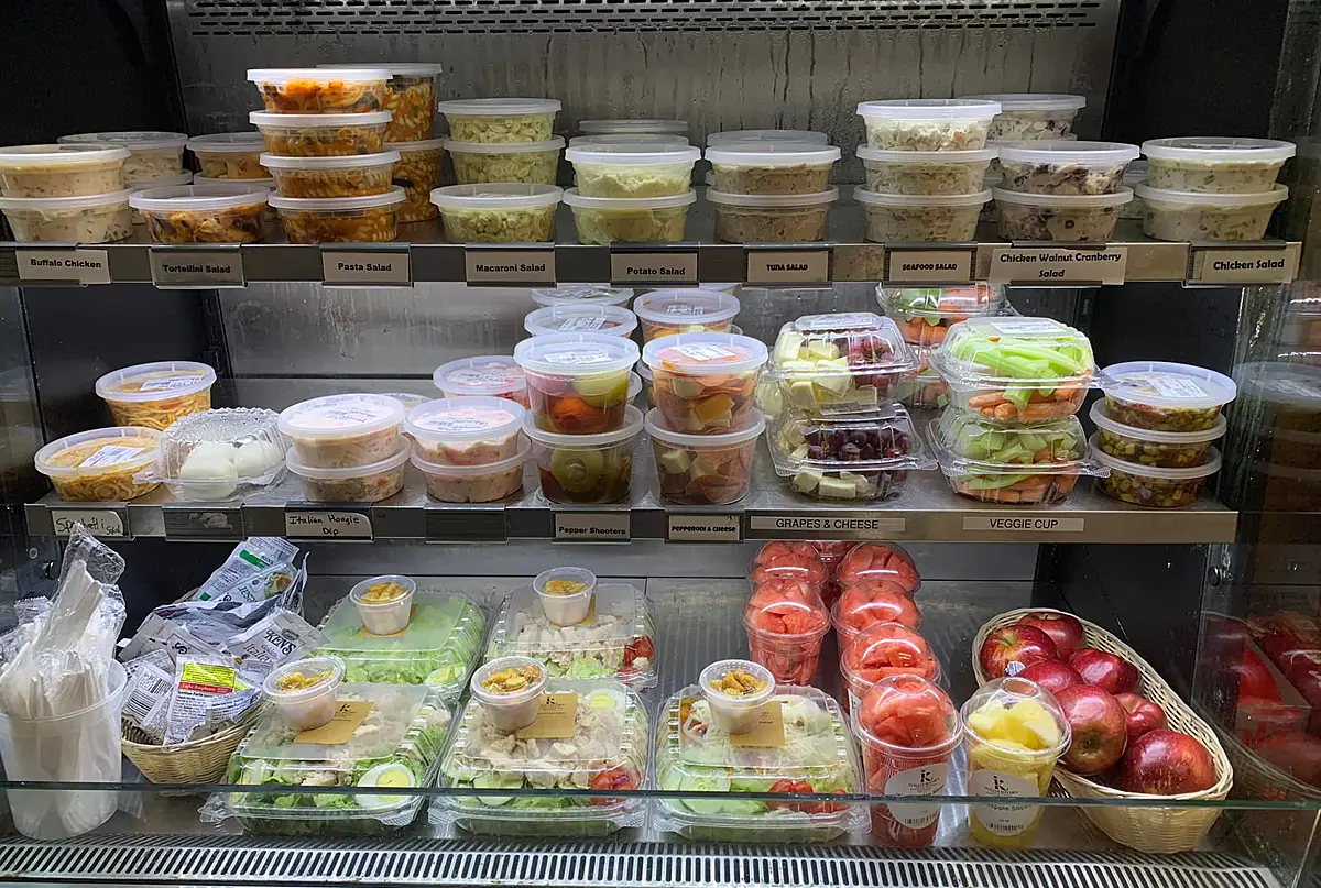 Display case with grab and go fruit, veggies and salads